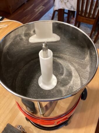 In operation, only the pot turns. The center spindle is fixed.